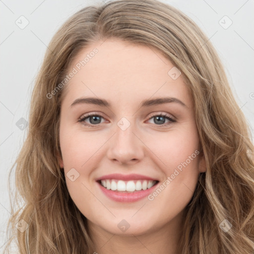 Joyful white young-adult female with long  brown hair and green eyes