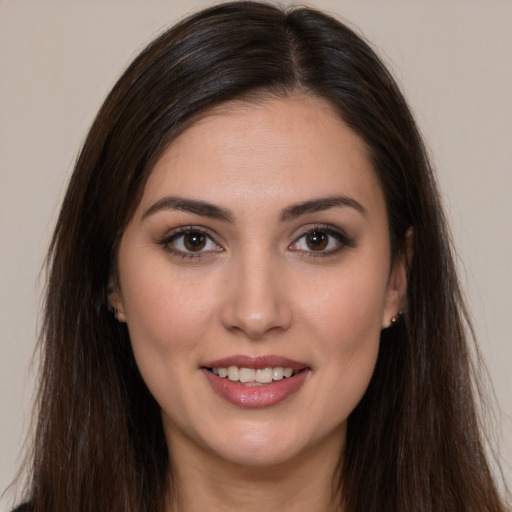 Joyful white young-adult female with long  brown hair and brown eyes