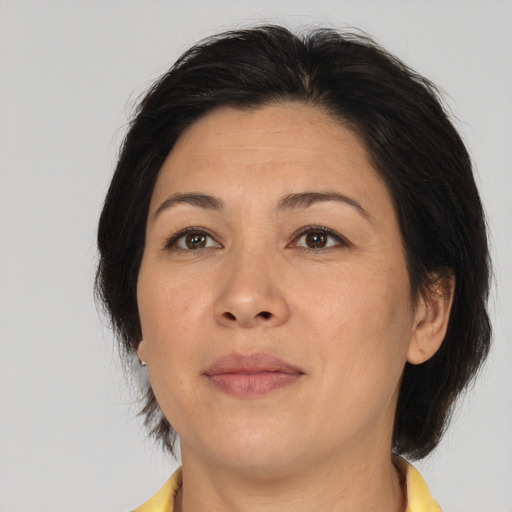 Joyful asian adult female with medium  brown hair and brown eyes