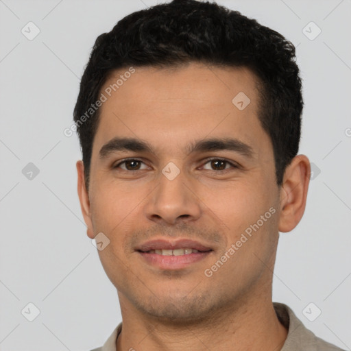 Joyful latino young-adult male with short  brown hair and brown eyes