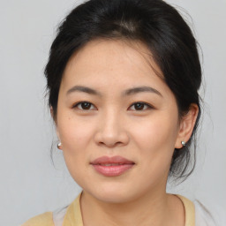 Joyful asian young-adult female with medium  brown hair and brown eyes