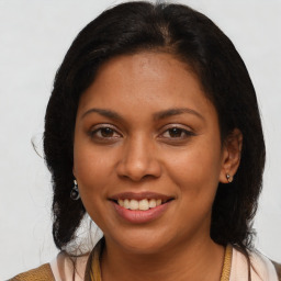 Joyful latino young-adult female with medium  brown hair and brown eyes