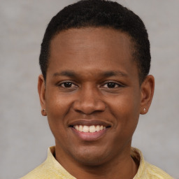 Joyful latino young-adult male with short  brown hair and brown eyes