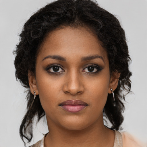 Joyful black young-adult female with medium  brown hair and brown eyes