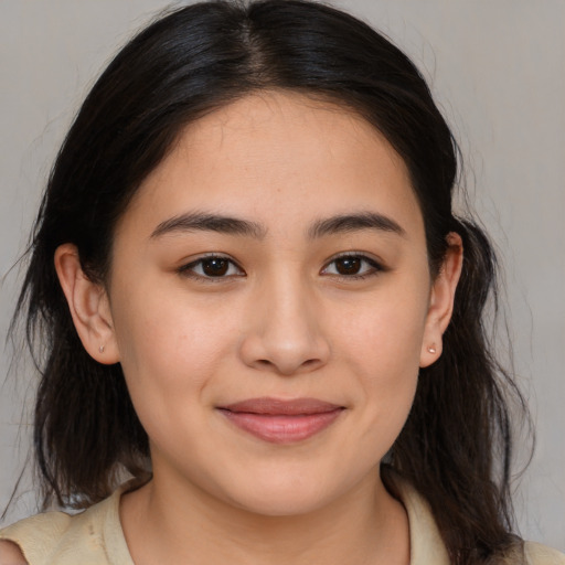 Joyful latino young-adult female with medium  brown hair and brown eyes