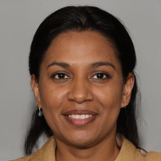 Joyful black adult female with medium  black hair and brown eyes