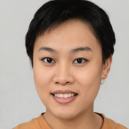 Joyful asian young-adult female with short  black hair and brown eyes