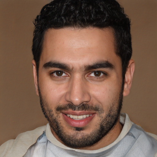 Joyful white young-adult male with short  black hair and brown eyes