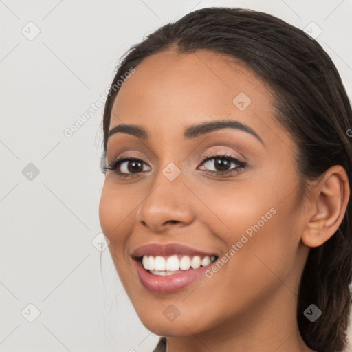 Joyful latino young-adult female with long  brown hair and brown eyes