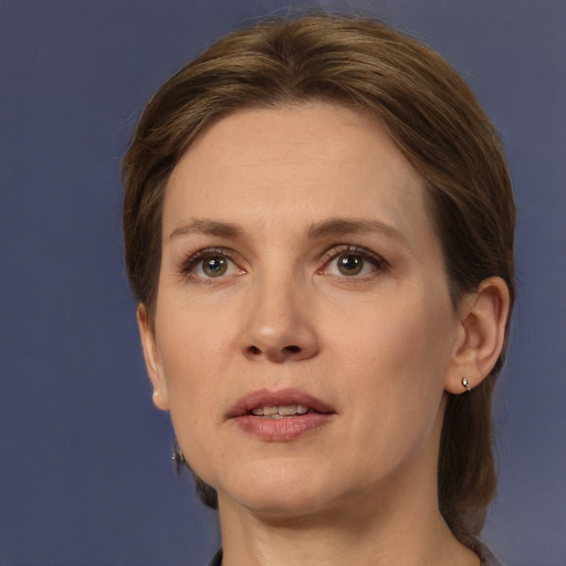 Joyful white adult female with medium  brown hair and grey eyes