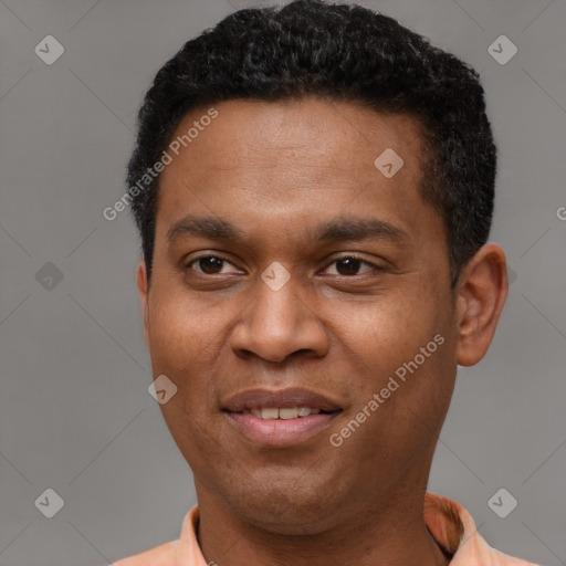 Joyful black young-adult male with short  black hair and brown eyes