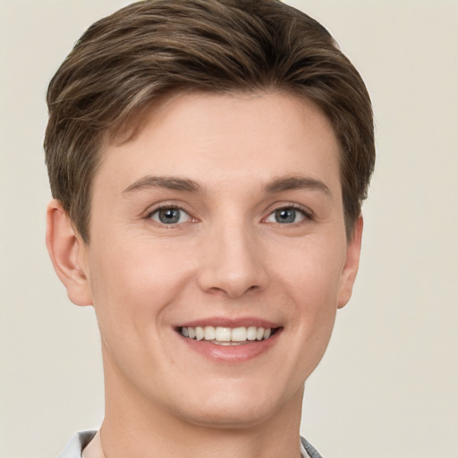 Joyful white young-adult female with short  brown hair and grey eyes