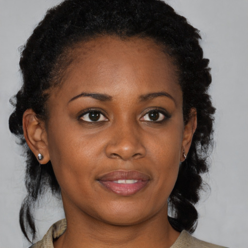 Joyful black young-adult female with medium  brown hair and brown eyes
