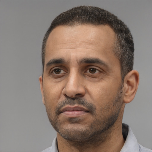 Neutral black adult male with short  black hair and brown eyes