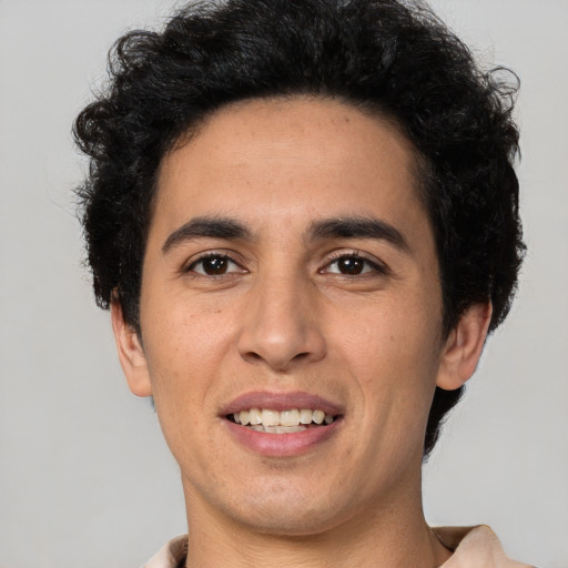 Joyful white young-adult male with short  black hair and brown eyes