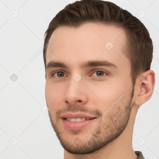 Joyful white young-adult male with short  brown hair and brown eyes