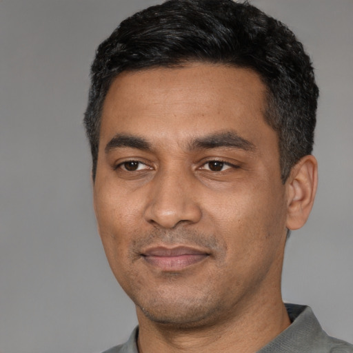 Neutral latino adult male with short  black hair and brown eyes