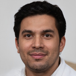 Joyful white young-adult male with short  black hair and brown eyes