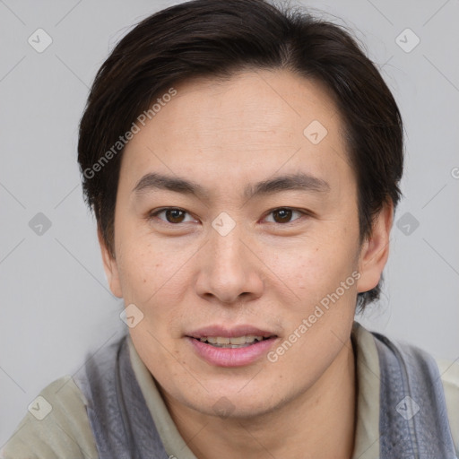 Joyful asian young-adult male with short  brown hair and brown eyes