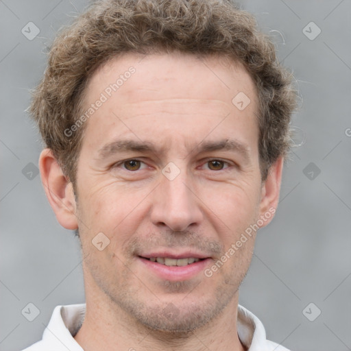 Joyful white adult male with short  brown hair and grey eyes