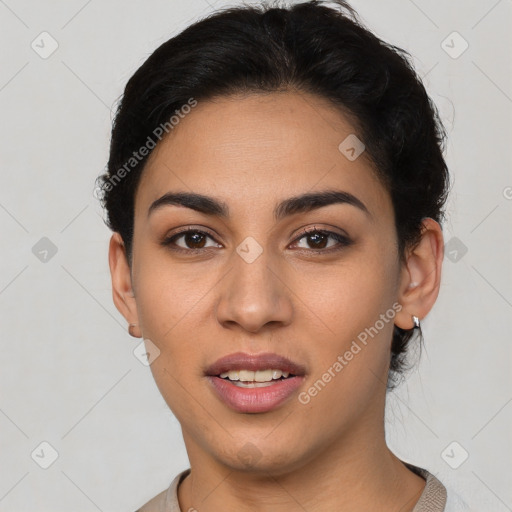 Joyful latino young-adult female with short  black hair and brown eyes