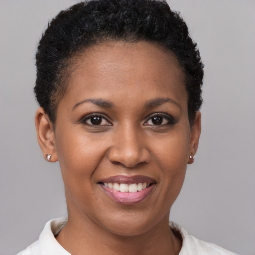 Joyful black young-adult female with short  brown hair and brown eyes
