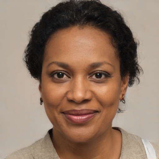 Joyful black adult female with short  brown hair and brown eyes