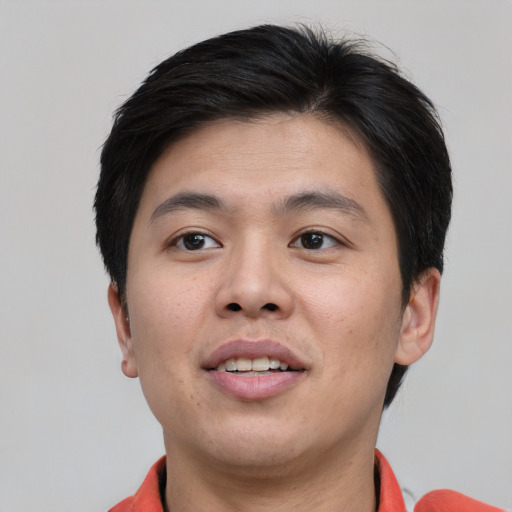 Joyful asian young-adult male with short  brown hair and brown eyes