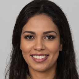 Joyful latino young-adult female with long  brown hair and brown eyes