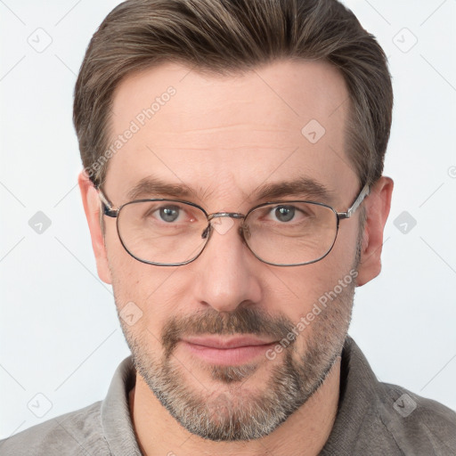 Joyful white adult male with short  brown hair and grey eyes