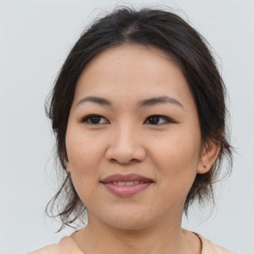 Joyful asian young-adult female with medium  brown hair and brown eyes