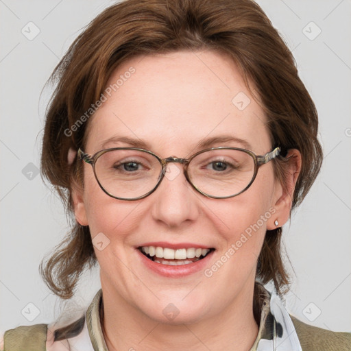 Joyful white adult female with medium  brown hair and blue eyes