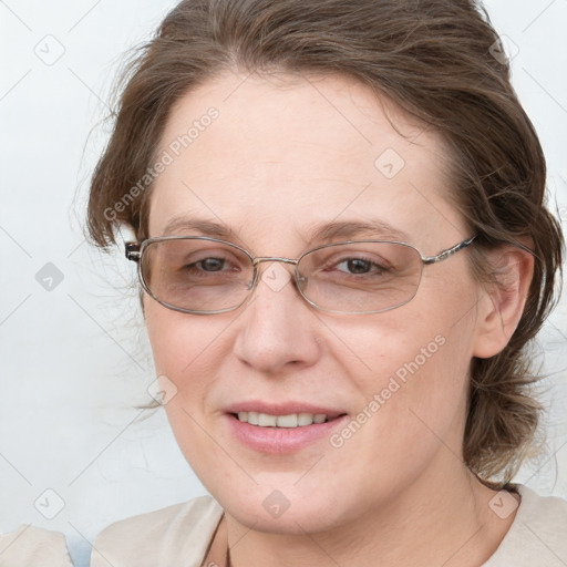 Joyful white adult female with medium  brown hair and blue eyes