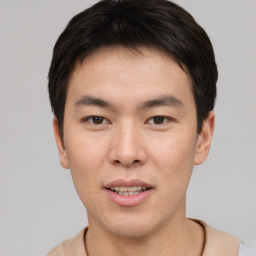 Joyful asian young-adult male with short  brown hair and brown eyes