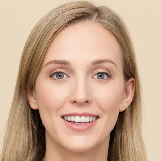 Joyful white young-adult female with long  brown hair and blue eyes