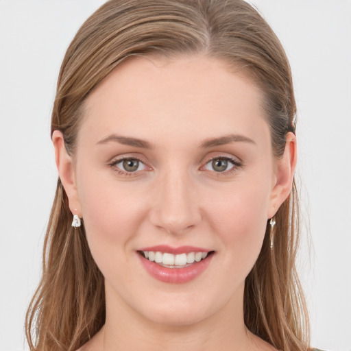 Joyful white young-adult female with long  brown hair and grey eyes