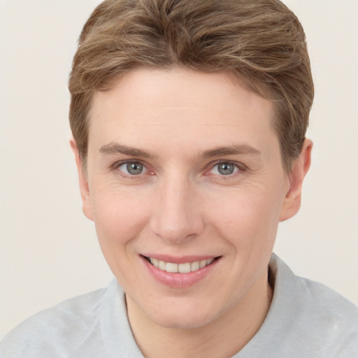 Joyful white young-adult female with short  brown hair and grey eyes