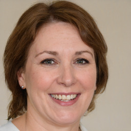 Joyful white adult female with medium  brown hair and grey eyes