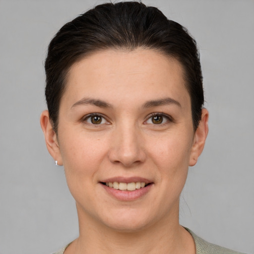 Joyful white young-adult female with short  brown hair and brown eyes