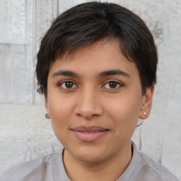 Joyful latino young-adult male with short  brown hair and brown eyes