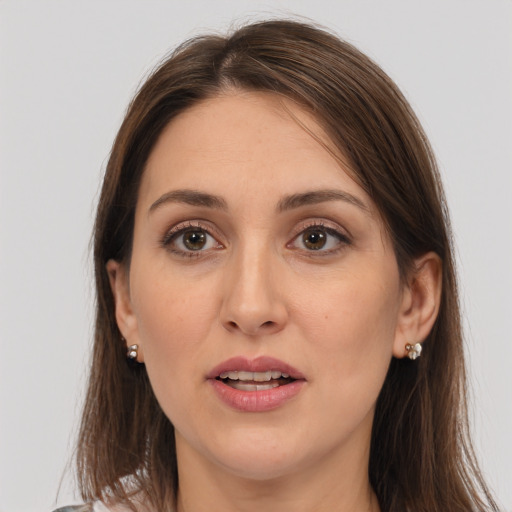 Joyful white adult female with long  brown hair and brown eyes