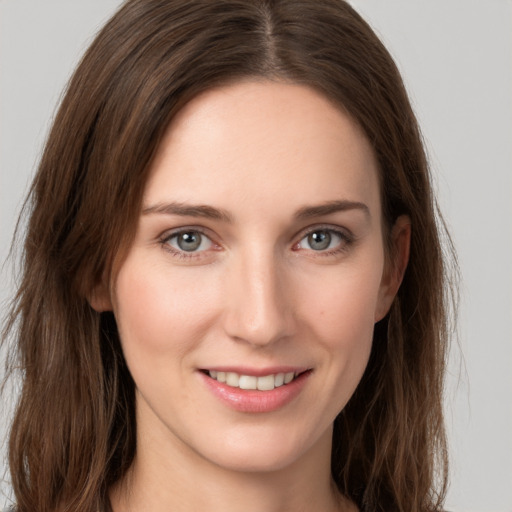 Joyful white young-adult female with long  brown hair and grey eyes