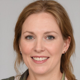 Joyful white young-adult female with medium  brown hair and blue eyes