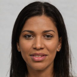 Joyful latino young-adult female with long  brown hair and brown eyes