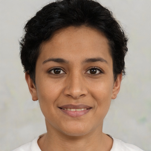 Joyful latino young-adult female with short  black hair and brown eyes