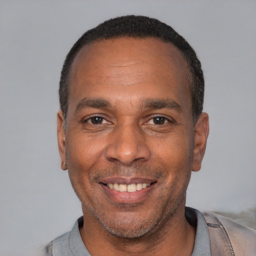 Joyful latino adult male with short  black hair and brown eyes