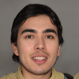 Joyful white young-adult male with medium  brown hair and brown eyes