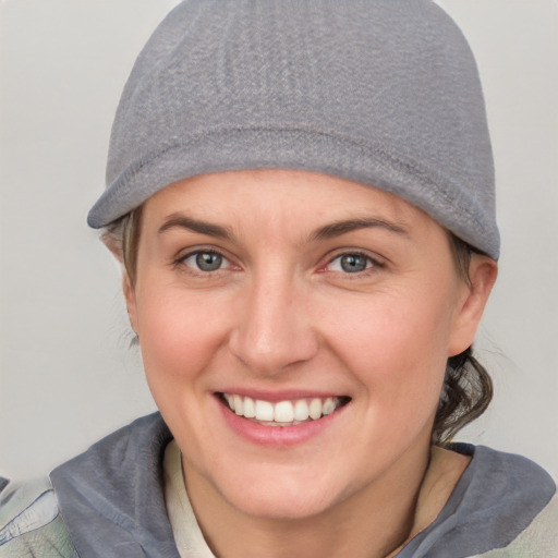 Joyful white young-adult female with short  brown hair and blue eyes