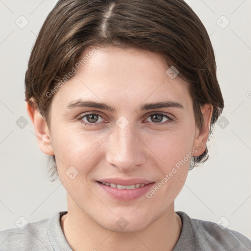 Joyful white young-adult female with short  brown hair and grey eyes