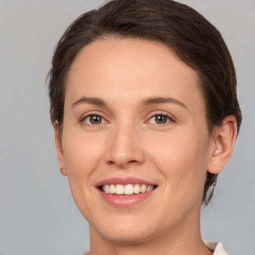 Joyful white young-adult female with medium  brown hair and brown eyes